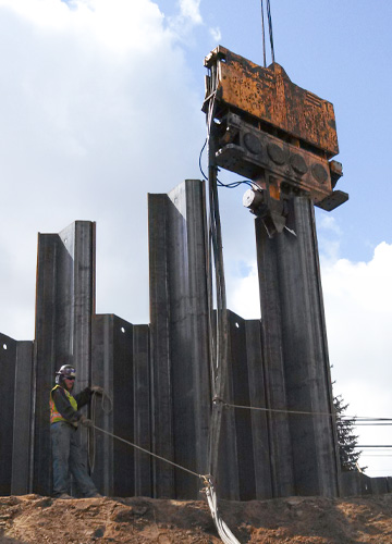 sheet pile being placed by a crane