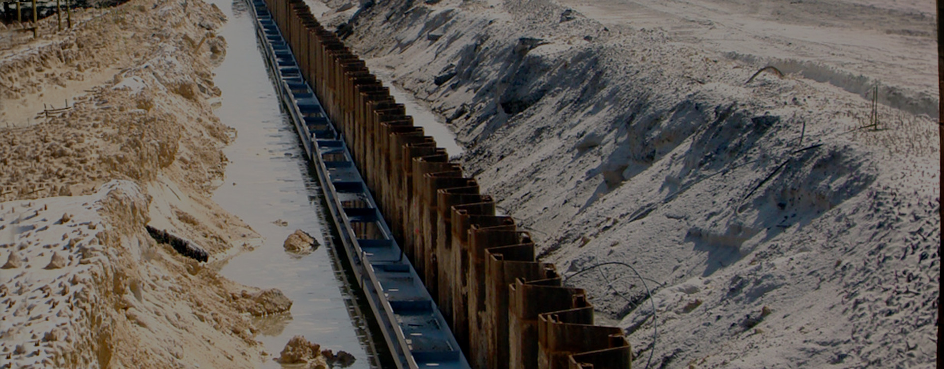 steel retaining wall being built in sand